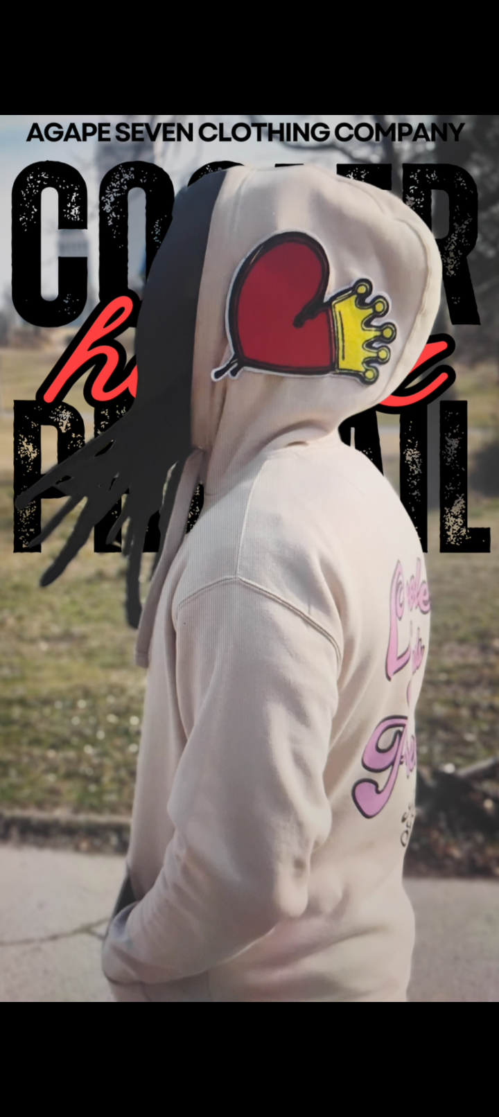 Person wearing Agape Seven Clothing Company hoodie featuring heart design in Cooler Heads Prevail: Stylish Solutions for Everyday Calm.