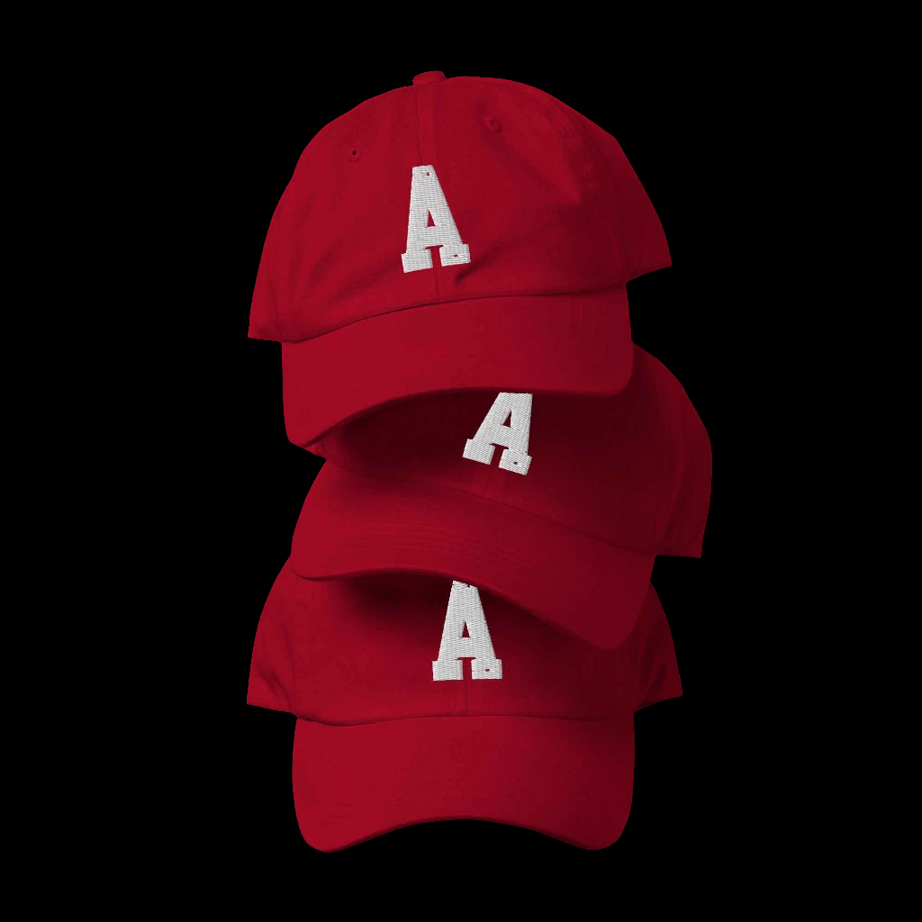 The A dad hat by Agape Seven displayed in a stack, featuring a bold letter A design on a vibrant red background.